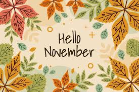 An autumn-themed image features the text "Hello November" in a casual handwritten font on a light beige background. The text is surrounded by a border of stylized fall leaves in shades of orange, green, and red, with various small abstract shapes scattered around.